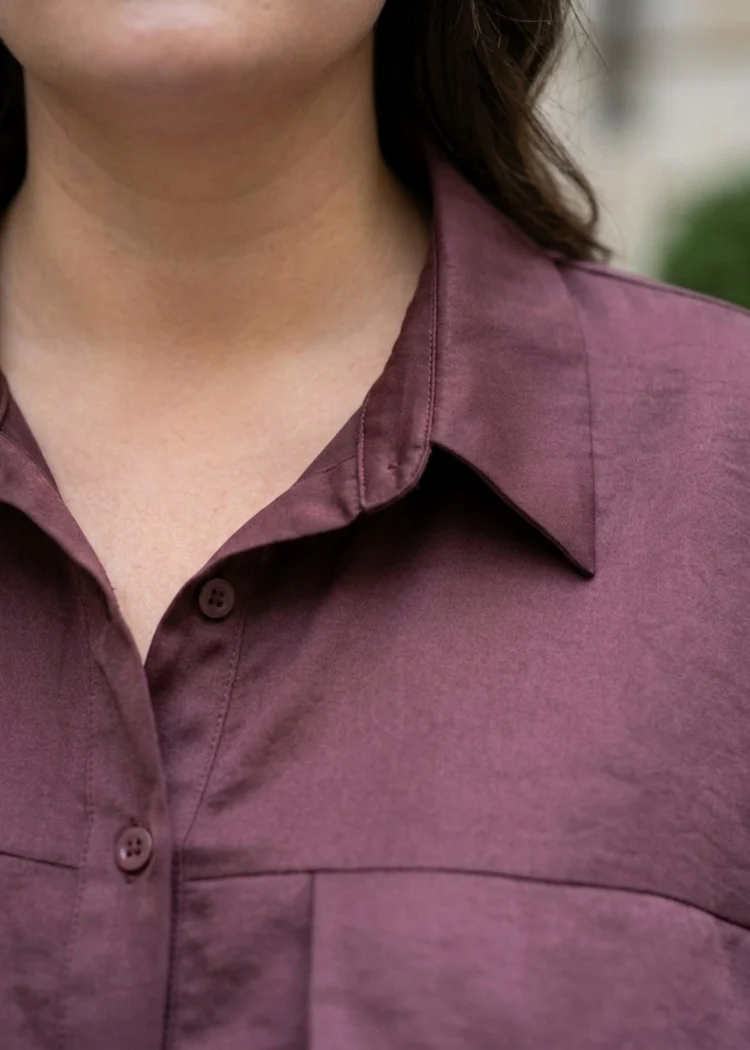 Koszula damska plus size z ozdobną kieszonką, zbliżenie na klasyczny kołnierzyk i zapięcie na guziki.