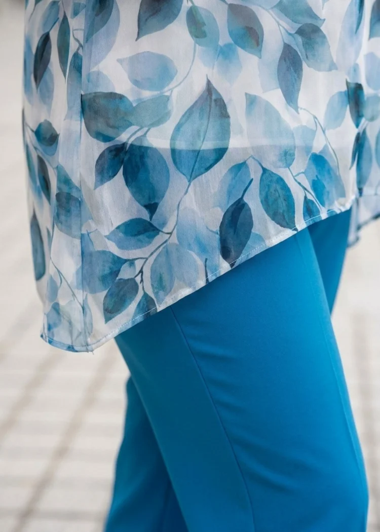 Tunika damska Elegancka dwuwarstwowa w niebieskie liście, zbliżenie na asymetryczny dół i dwuwarstwową